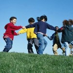 children_circle_playing_energetic_grass_sky
